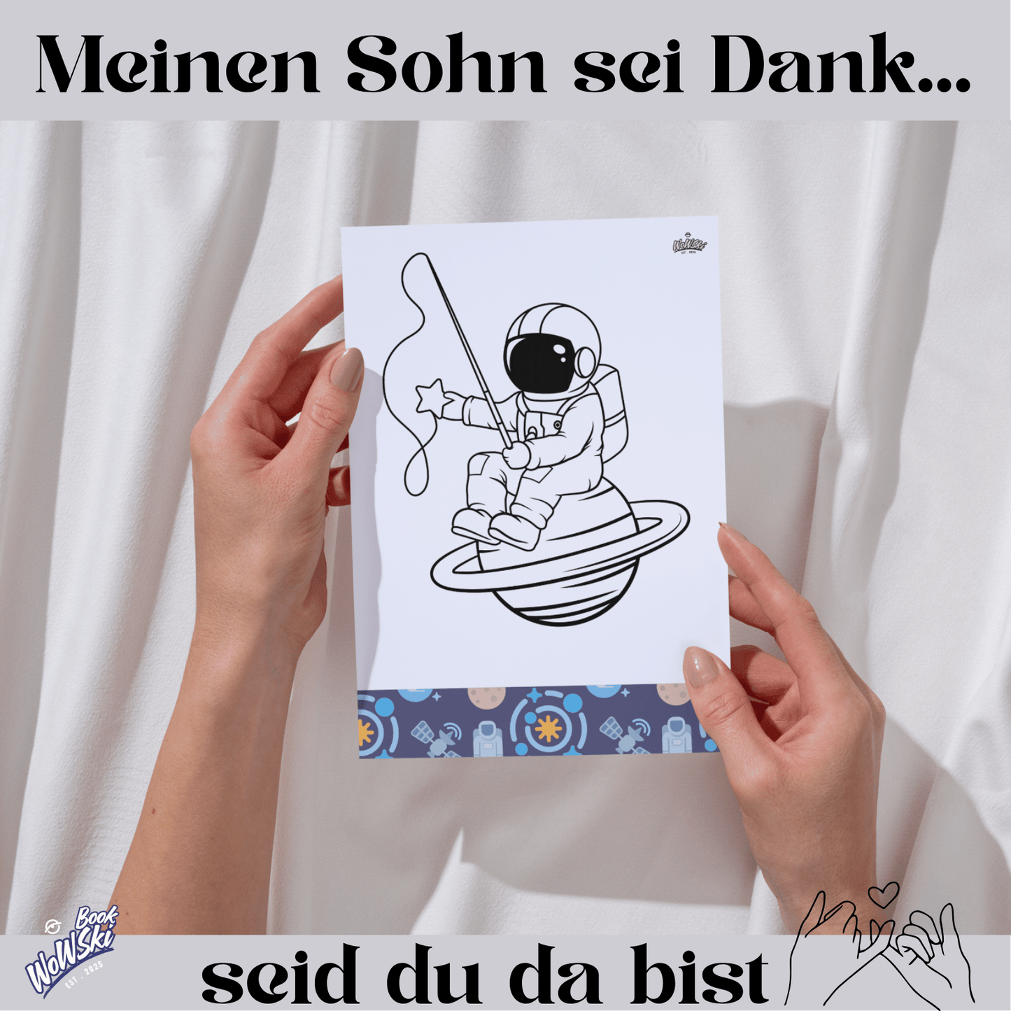 Text: Mein Sohn sei dank, seid du da bist. MockUp: Hände mit Malvorlage: Astronaut sitz auf einem Planeten und angelt Sterne .links unten Logo:"wowski-book"